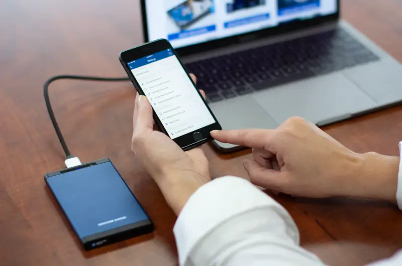 SecureDrive BT on desk with phone app and laptop