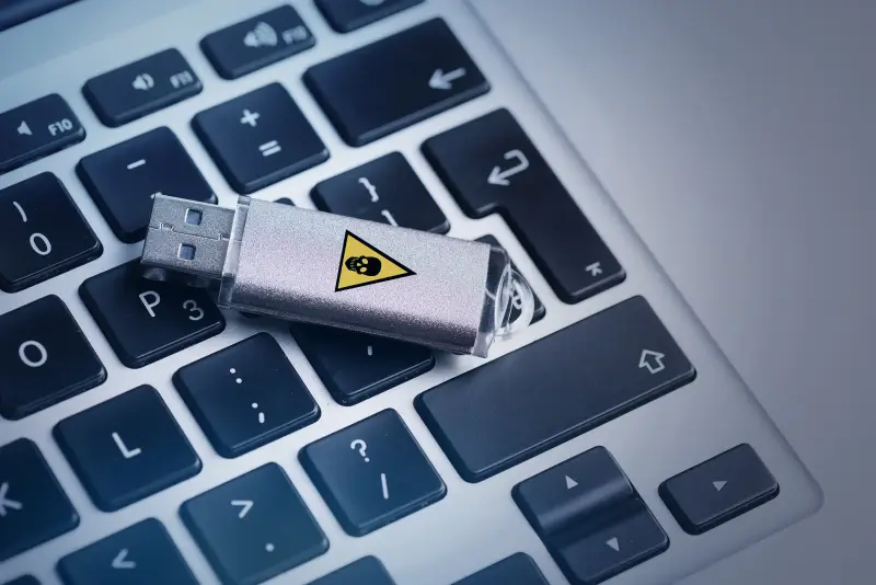 An image of a flash drive with a graphic that suggests it is infected with malware.
