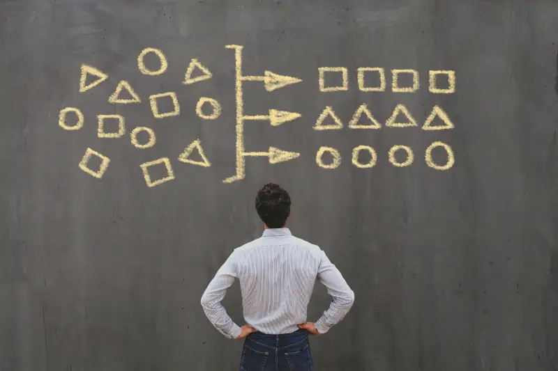 Man looking at whiteboard with data categories concept