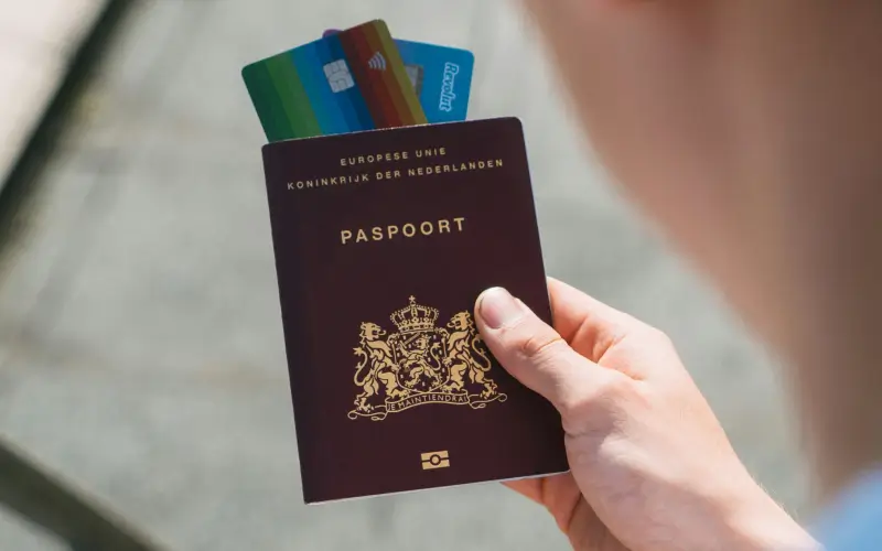 Person holding passport with RFID card